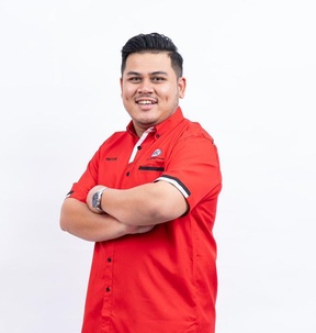 Sheikh Fhayzal, Executive Director, arms folded, in a red SBI shirt.
