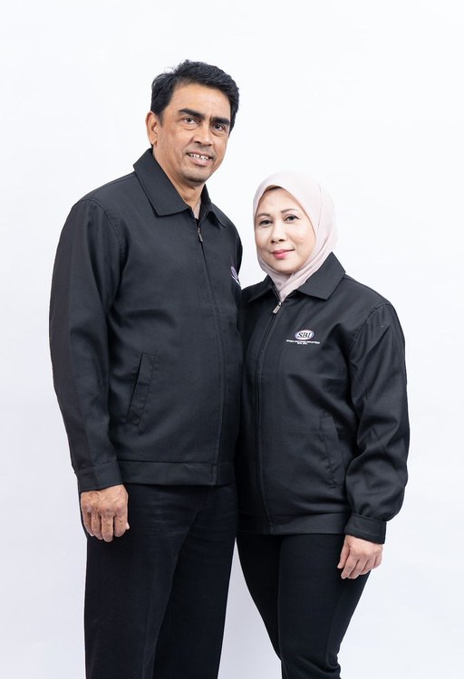 Dato’ Sheikh Rajesh and Datin Nazila, SBI’s founders, standing side by side in black SBI jackets.