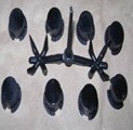 Eight black shipping plugs and their molded runner.